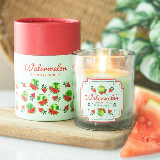 Watermelon scented candle with packaging on a wooden board