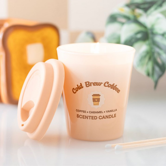 Cold brew coffee-scented candle with lid on a white surface