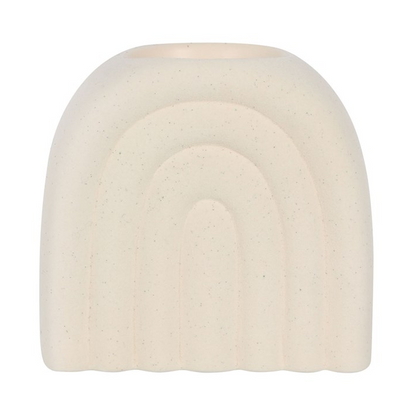 Round, beige-colored object with a rainbow design on a white background