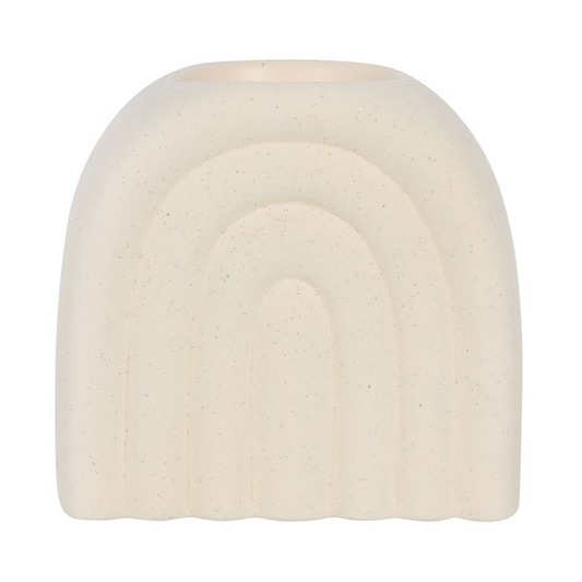 Round, beige-colored object with a rainbow design on a white background